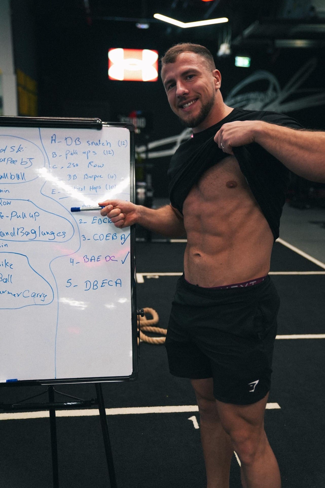 Coach reviewing a bespoke programme on the studio whiteboard
